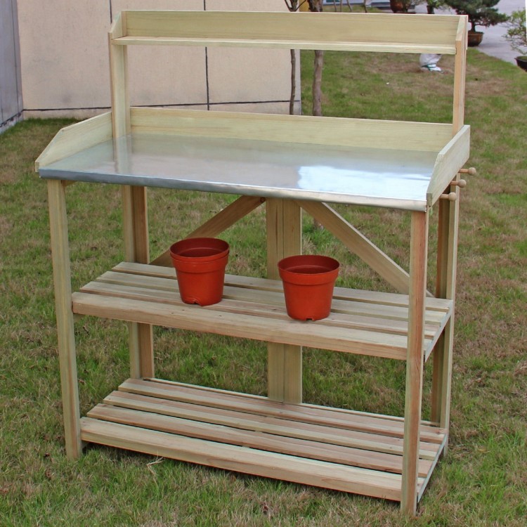 Wooden planting bench work station with metal top shelf and two lower shelves for organizing gardening tools and pots.