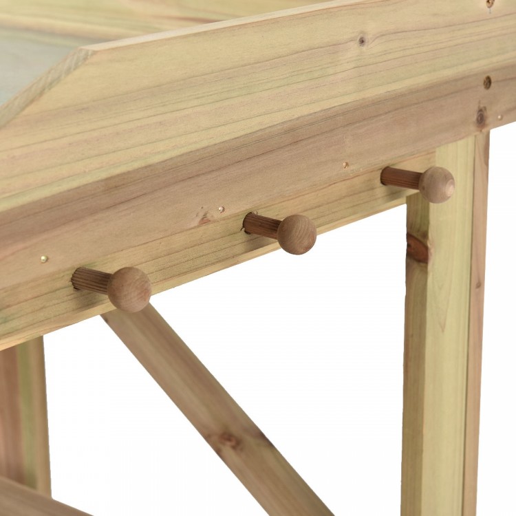 Close-up of the wooden pegs on the Garden Wooden Planting Bench Work Station for hanging garden tools and accessories.