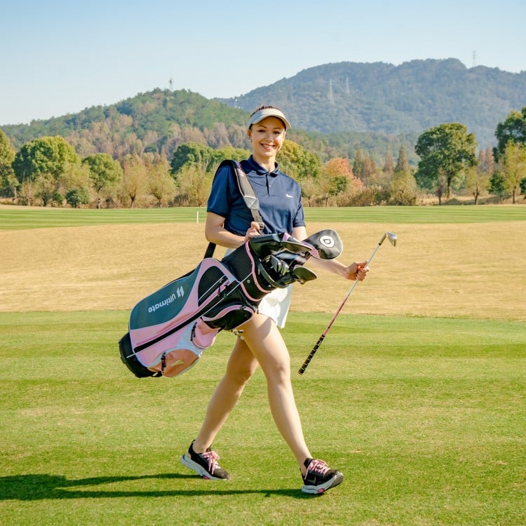 Women's golf club set in pink, featuring a padded shoulder strap and multiple pockets, perfect for the golf course.