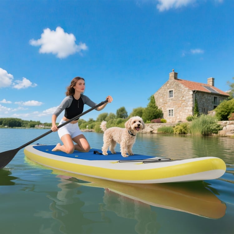 A young woman paddles an 11-foot inflatable SUP board with a dog, showcasing its stability and non-slip deck on a lake.