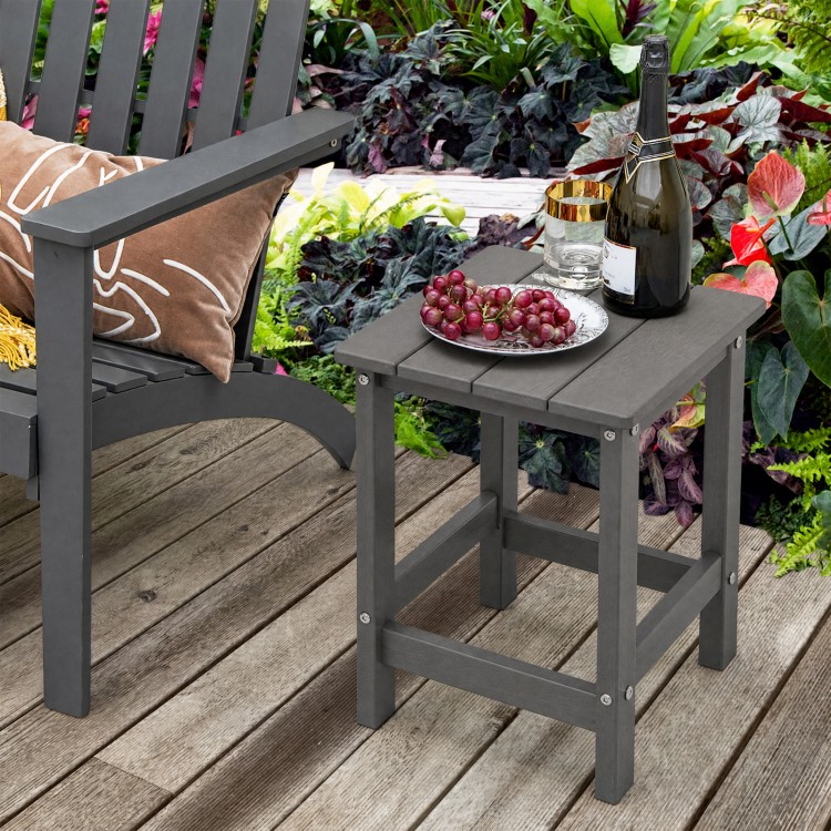 Gray weather-resistant Adirondack side table with slatted top, perfect for outdoor use beside your chair.