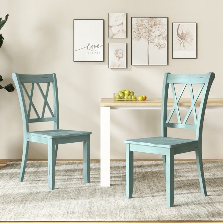 Set of 2 green rubber wood dining chairs with ergonomic backrest, perfect for home or cafe use.