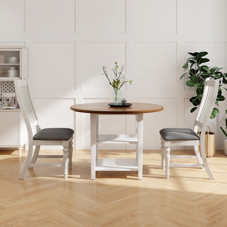 Set of 2 white dining chairs with solid wood legs and gray cushions, designed for comfort and stability in dining areas.