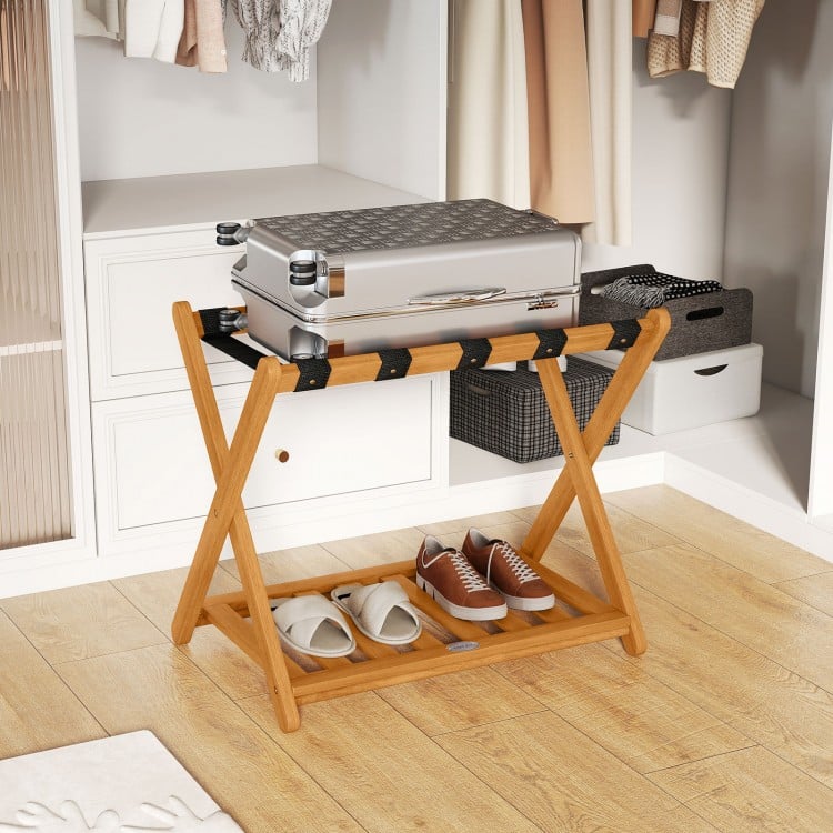 Folding luggage rack in solid acacia wood with 5 nylon straps and slatted shelf, perfect for bedroom or guest room use.