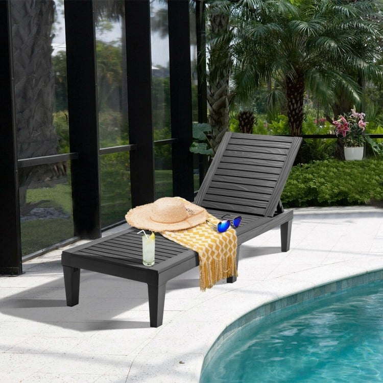 Black outdoor chaise lounge chair with adjustable backrest, perfect for poolside relaxation and easy maintenance.