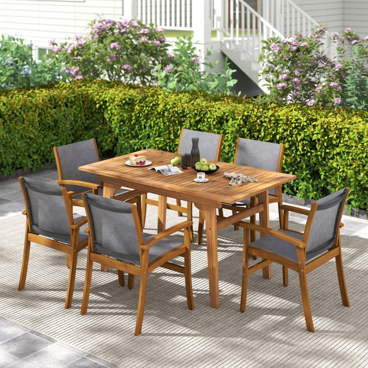 Overview of a patio dining set showcasing a solid acacia wood table surrounded by breathable fabric chairs for outdoor.