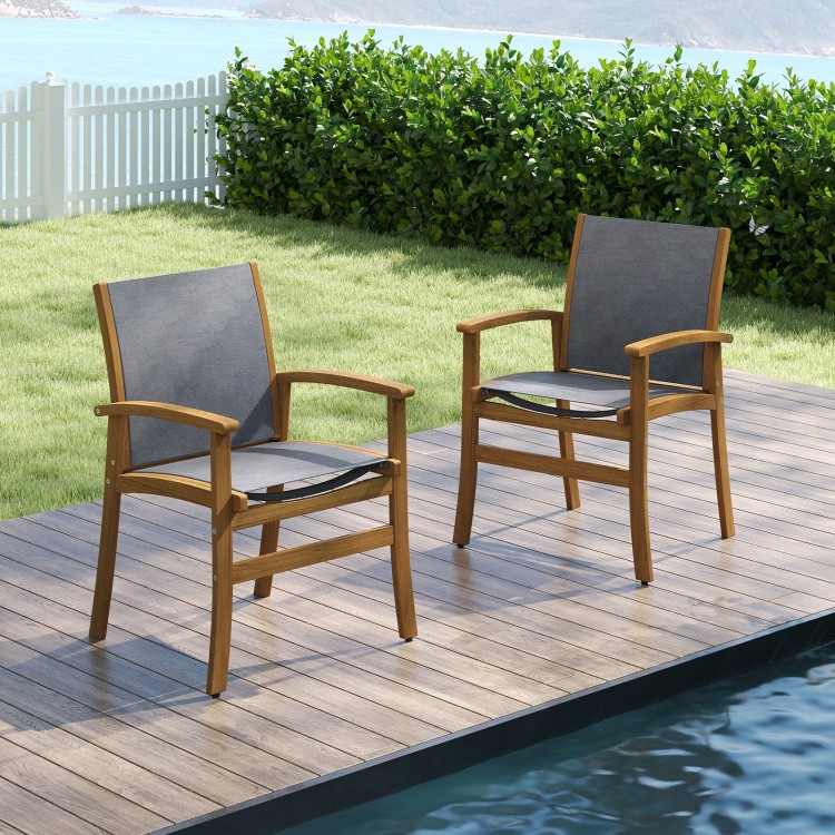 Set of 2 patio dining chairs with acacia wood frame and breathable fabric, perfect for outdoor dining by the poolside.