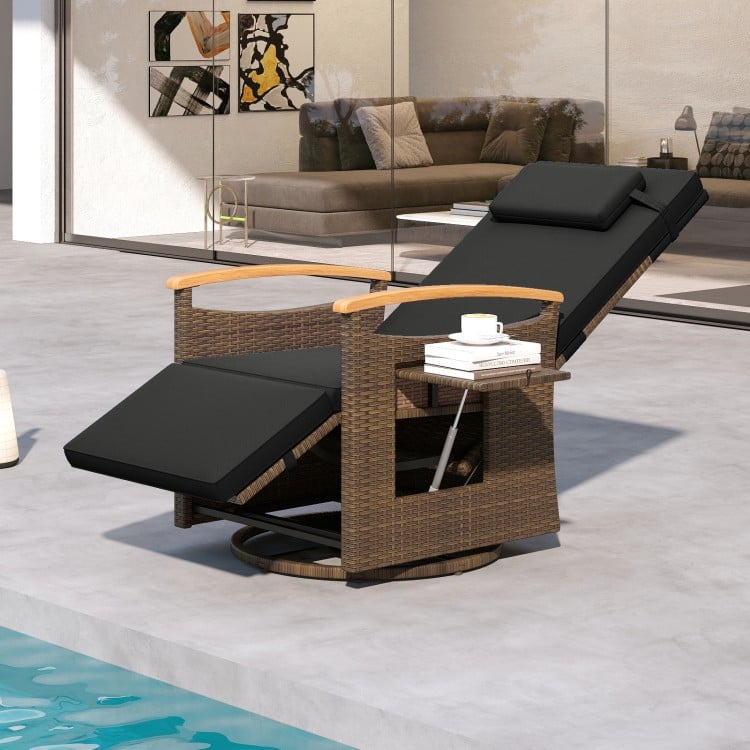 Black patio rattan swivel recliner chair with adjustable backrest, wood armrests, and side table for outdoor relaxation.