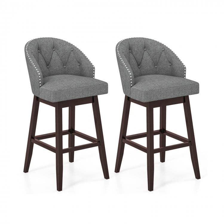 Set of 2 gray swivel bar stools with rubber wood legs, padded backrest, and stylish rivets for kitchen or pub use.