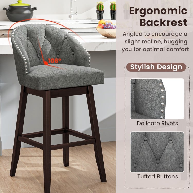 Gray swivel bar stool with ergonomic backrest, rubber wood legs, and tufted buttons, perfect for kitchen islands or.
