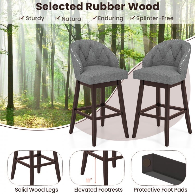 Set of 2 gray swivel bar stools with rubber wood legs, padded backrest, and elevated footrests for kitchen or pub use.