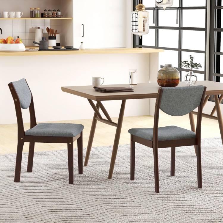 Set of 2 wood kitchen chairs with gray faux leather seats, featuring ergonomic backrests for comfort in a dining area.