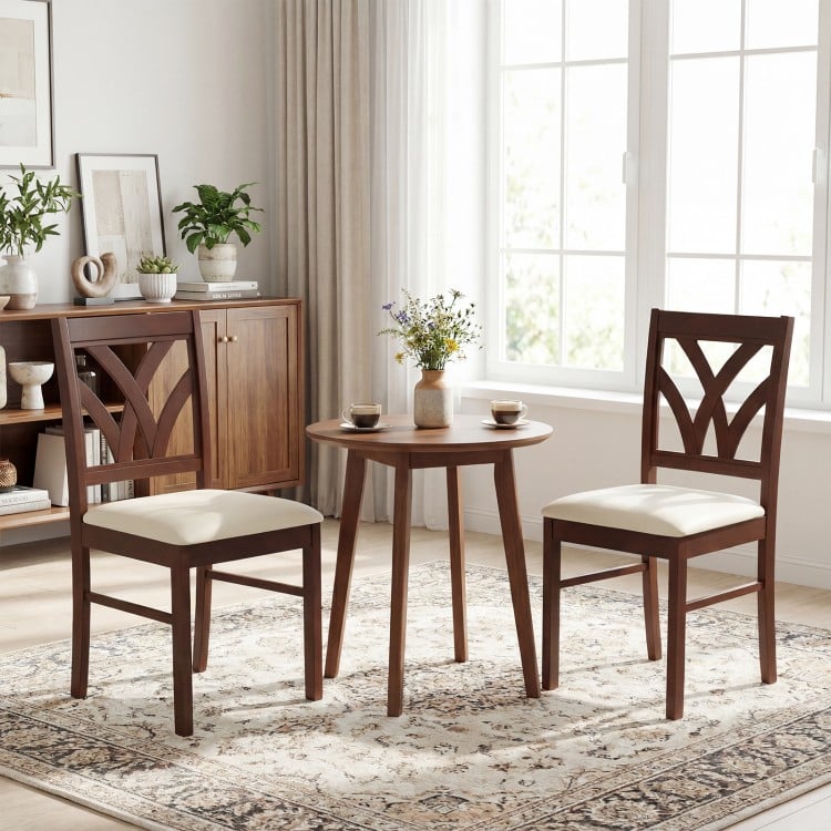 Set of 2 brown wooden dining chairs with upholstered padded seats and hollowed backrests, ideal for dining rooms.