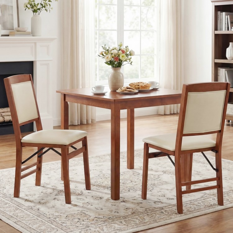 Folding dining chairs with padded seats and high backrests in walnut finish, perfect for compact dining spaces.