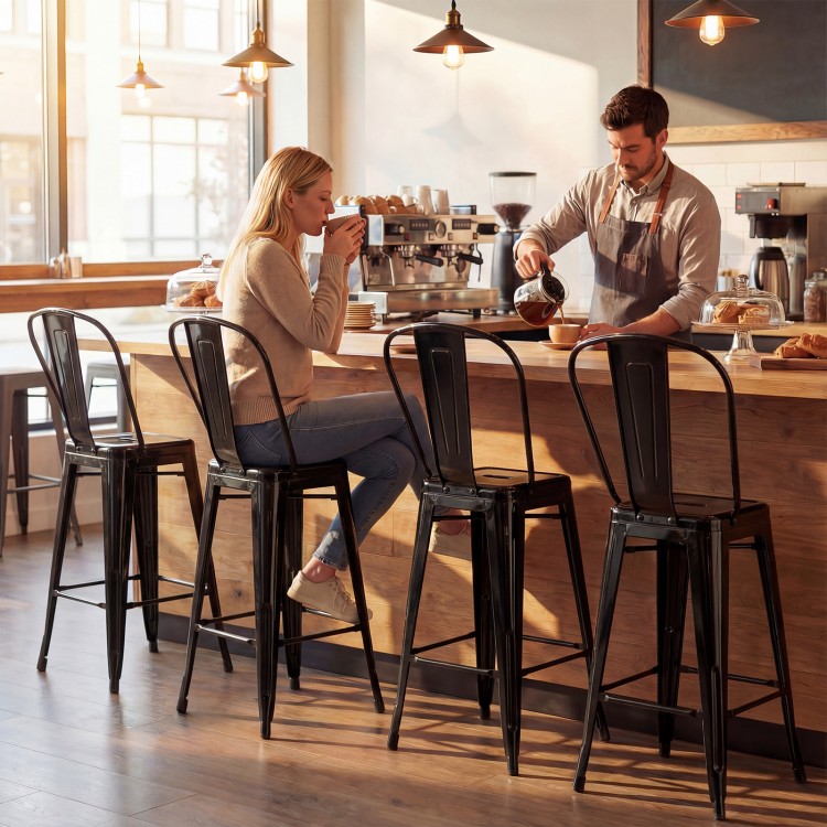 Black metal bar stools with backrests and footrests, ideal for kitchen islands and home bars, featuring a stackable.