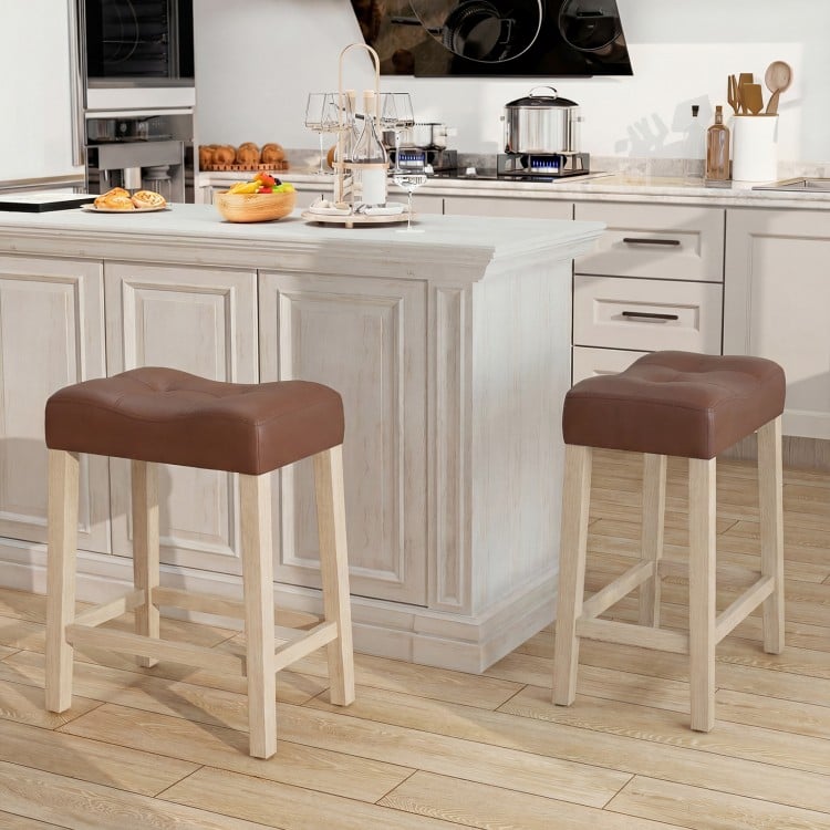 Upholstered counter height bar stools with curved saddle-seat, natural wood frame, perfect for kitchen or bar use.