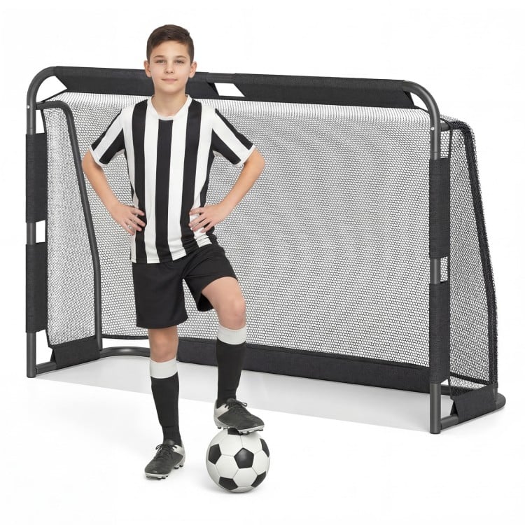 Youth soccer player posing with a 6 ft x 4 ft metal frame soccer goal set, ideal for backyard training and recreation.