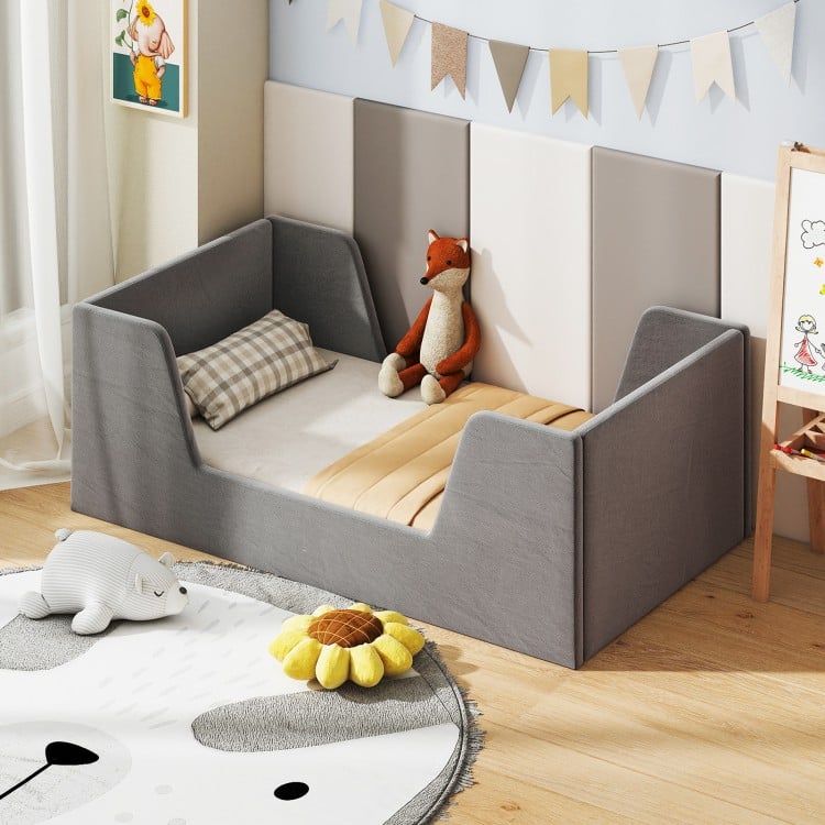 Gray soft velvet toddler bed frame with safety rails and wooden slats, designed for comfort and stability in a child's.