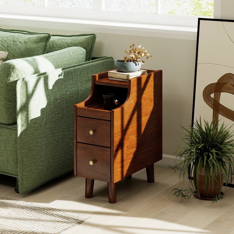 Narrow solid wood end table in brown with pull-out tray and two drawers, perfect for bedside storage and organization.