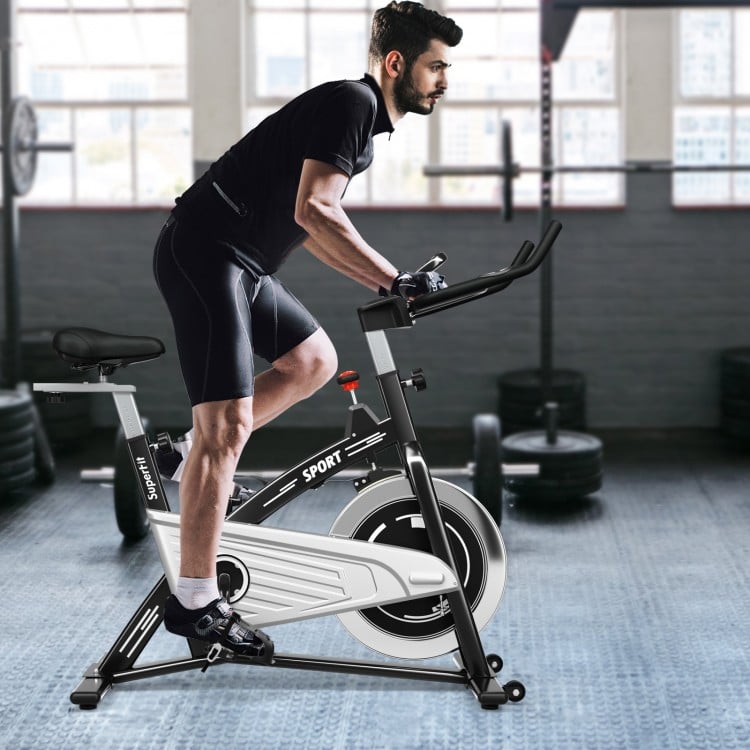 Spinning bike with 30 lbs flywheel, adjustable seat and handlebars, ideal for home and gym workouts.