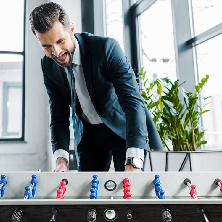 Competition-sized 48" wooden foosball table in black with ergonomic handles, ideal for game rooms and offices.