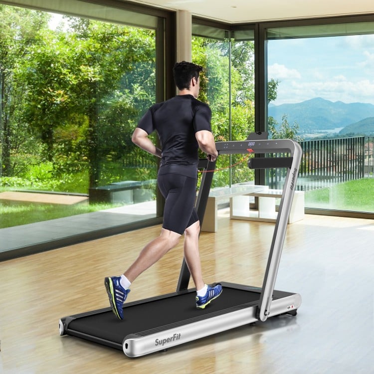Folding treadmill in silver with a user running, featuring a touch screen and remote control for fitness tracking.