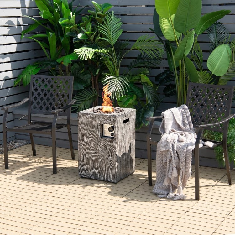 Square outdoor propane fire pit with lava rocks, featuring a durable design and waterproof cover for patio relaxation.