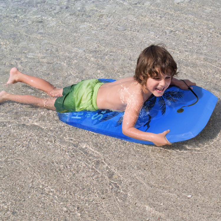Child enjoying the Super Lightweight Bodyboard Surfing in blue with palm design, perfect for outdoor water sports.