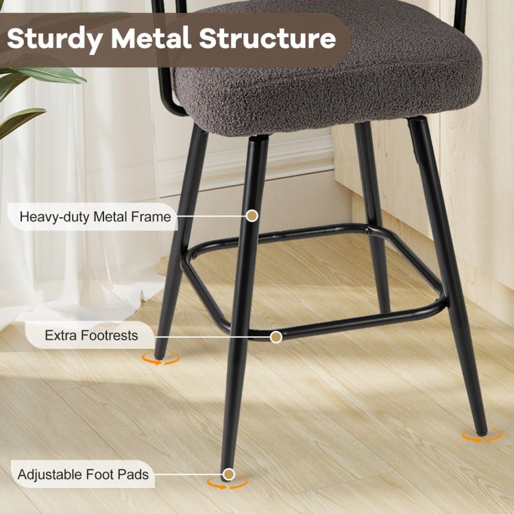 Close-up of the swivel bar stool's sturdy metal frame with adjustable foot pads, featuring a grey boucle cover.