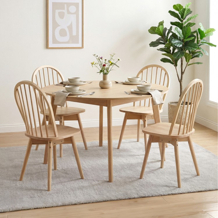 Set of four Swivel Windsor dining chairs in natural rubber wood, featuring a spindle back and wide seats for comfort.