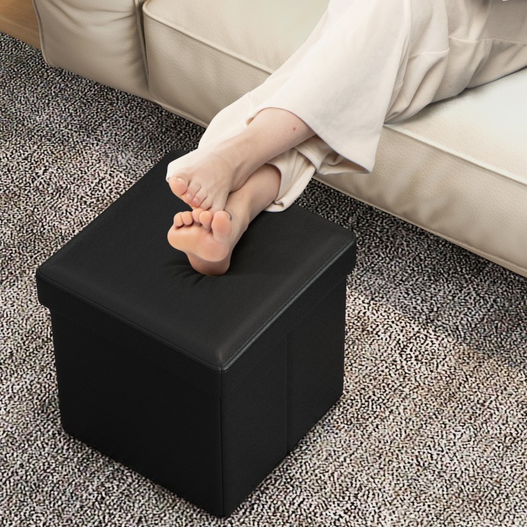 Black upholstered square footstool with PVC leather surface, ideal for storage and comfort in living room or bedroom.