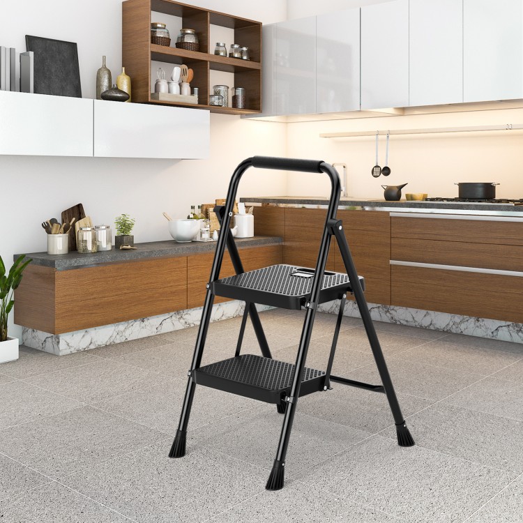 Portable folding 2 step ladder in black with anti-slip pedals and foam handle, ideal for kitchen use and easy storage.