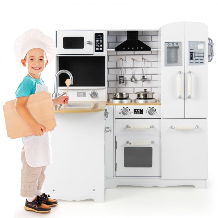 Wooden kid's corner kitchen playset in natural and white with stove, microwave, and ample storage for imaginative play.
