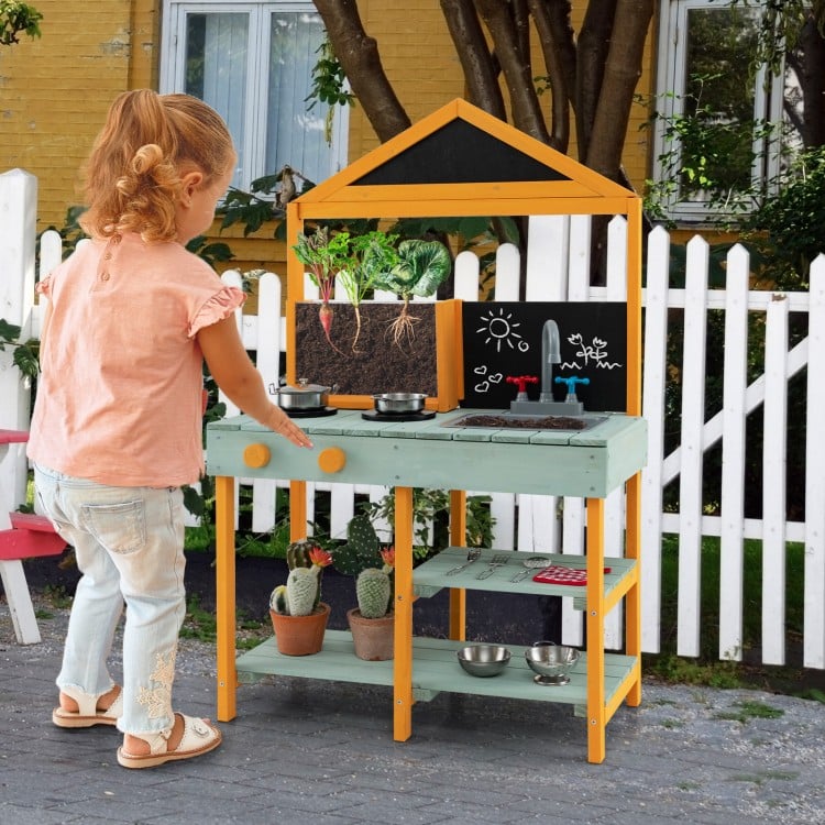 Kids kitchen playset featuring a root viewer planter, rotatable faucet, and chalkboards for creative play in a garden.