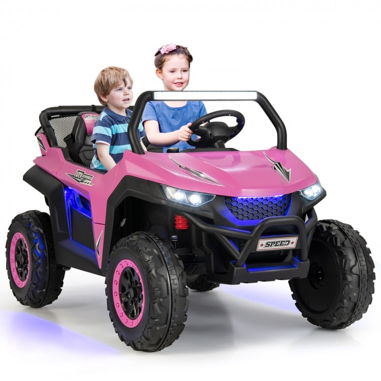Two kids enjoying a pink 12V UTV ride-on car with safety features and music, perfect for outdoor fun.