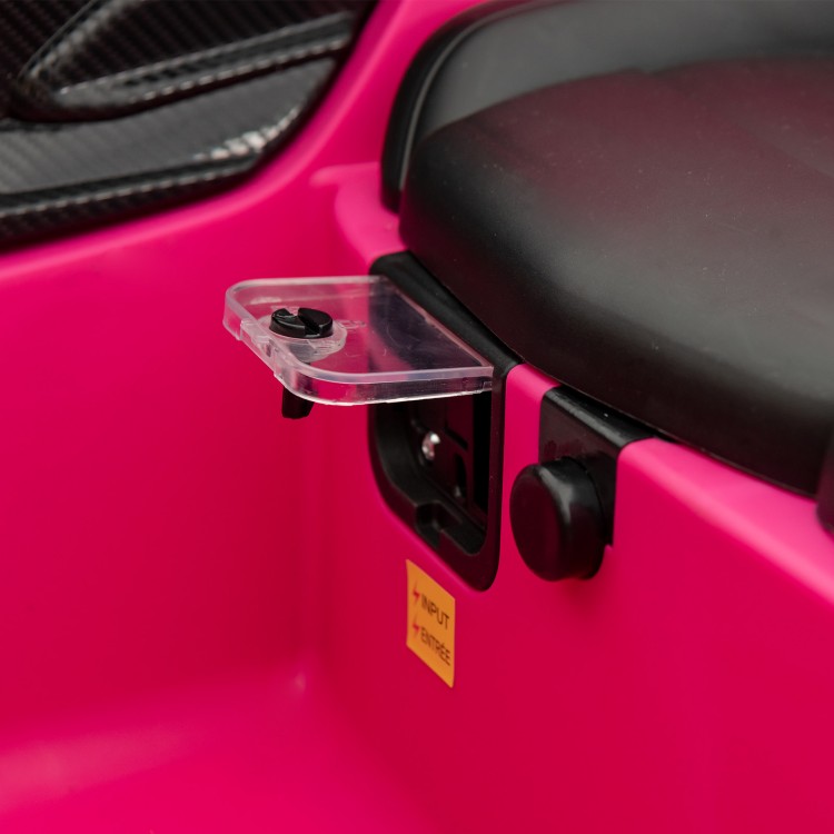 Close-up of the control panel on the pink 12V Lamborghini kids ride-on car with integrated AUX and USB ports.
