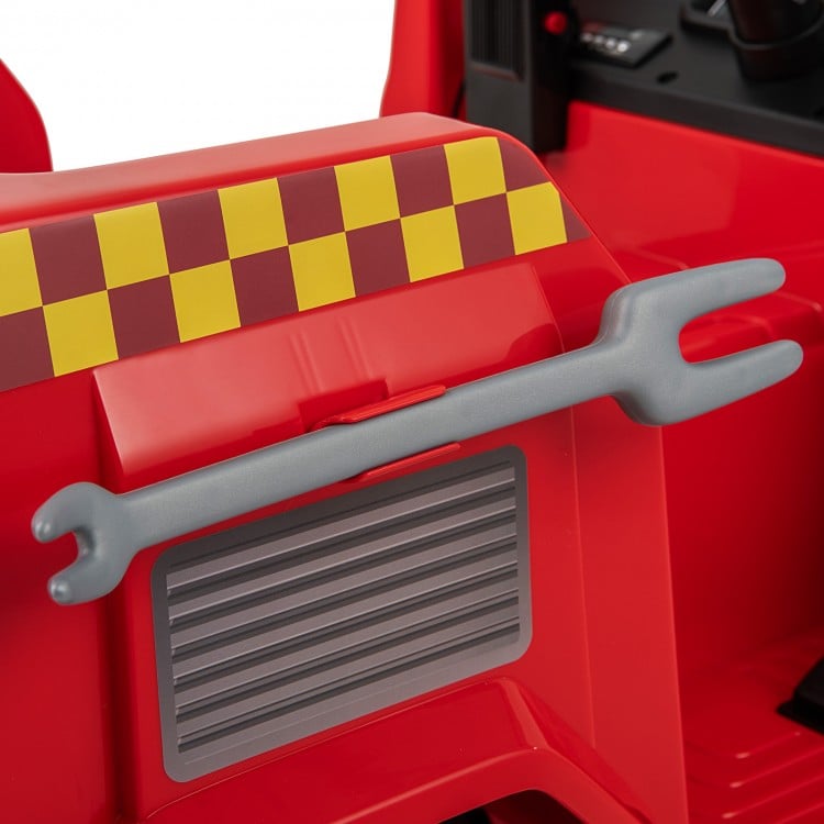 Red ride-on fire truck detail featuring a wrench and shovel for kids to learn basic skills while enjoying imaginative.