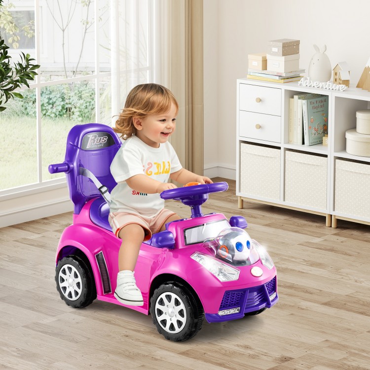 Toddler riding in a pink 3-in-1 push car with steering wheel, interactive buttons, and removable guardrail for safety.