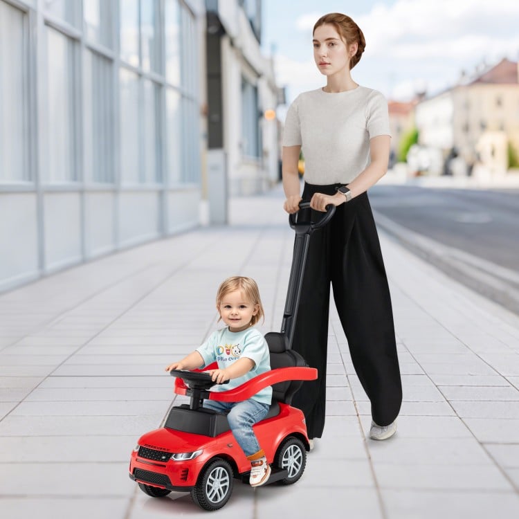 Red 3 in 1 push car for kids with removable handle and guardrail, ideal for ages 18-36 months, shown on a city street.