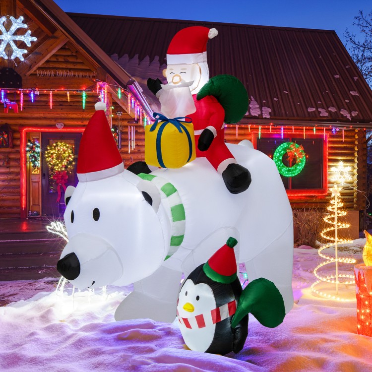 Inflatable Santa Claus riding a polar bear with a penguin, featuring LED lights, for festive outdoor decoration.