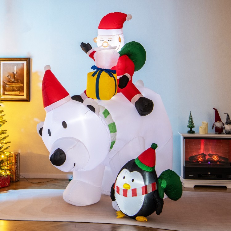 Inflatable Santa Claus riding a polar bear with a penguin, featuring LED lights, perfect for festive yard decoration.