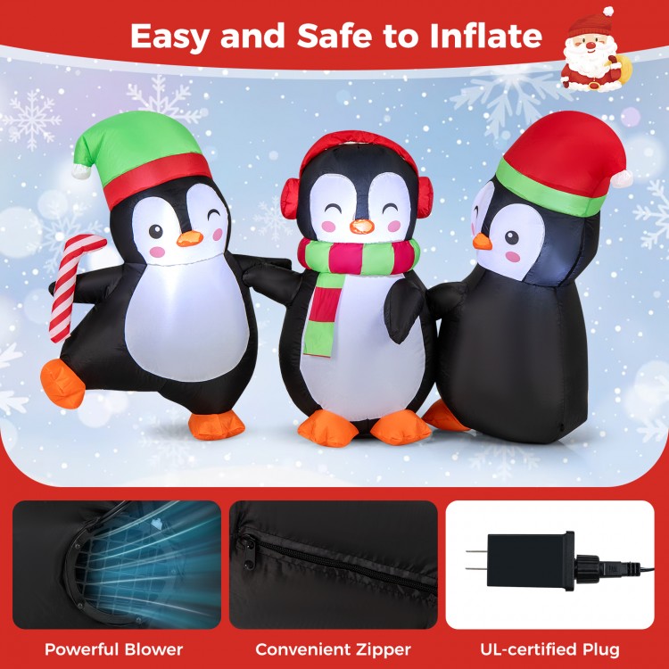 Christmas inflatable penguins family with LED lights, wearing Santa hats and candy canes, perfect for festive displays.