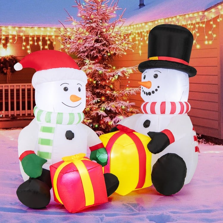 Cute 5-foot inflatable snowmen with gift boxes, pre-lit with LED lights for festive holiday decor.