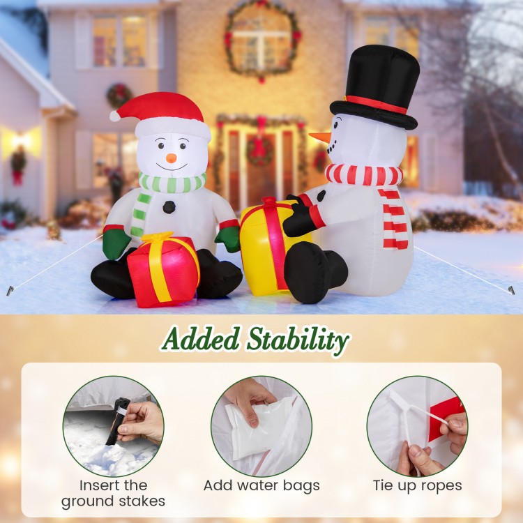 Cute 5-foot inflatable snowmen with gift boxes, pre-lit with LED lights, ideal for festive outdoor holiday displays.