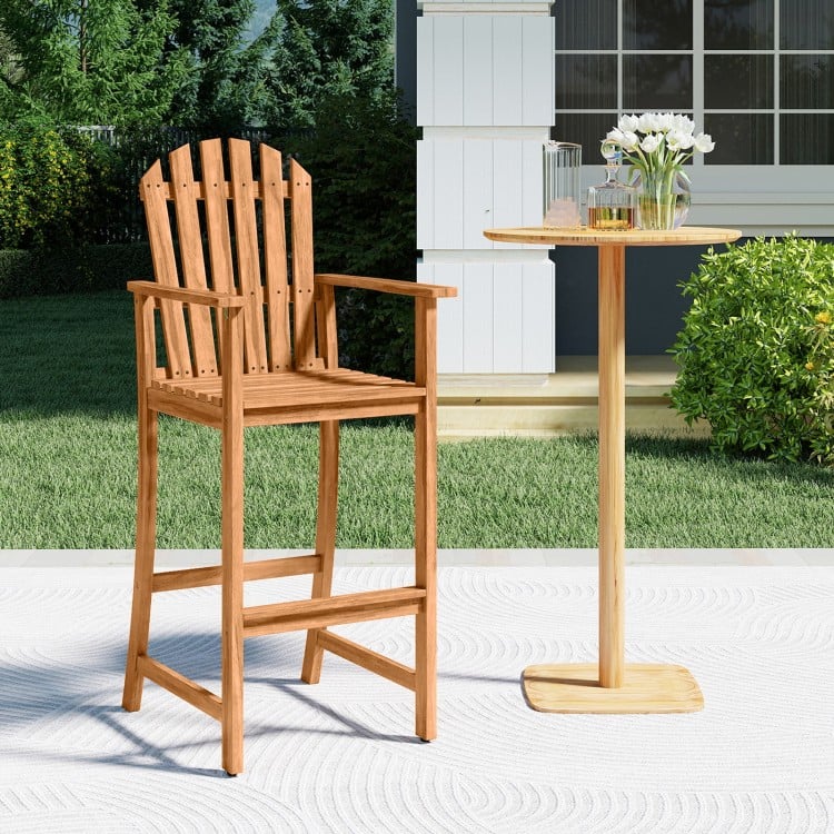 Tall Adirondack chair made of solid acacia wood with armrests and footrest, ideal for patio and deck seating.