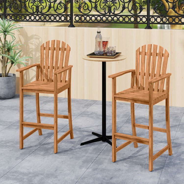 Tall Adirondack chairs with armrests and footrests made of acacia wood, ideal for patio and deck seating.