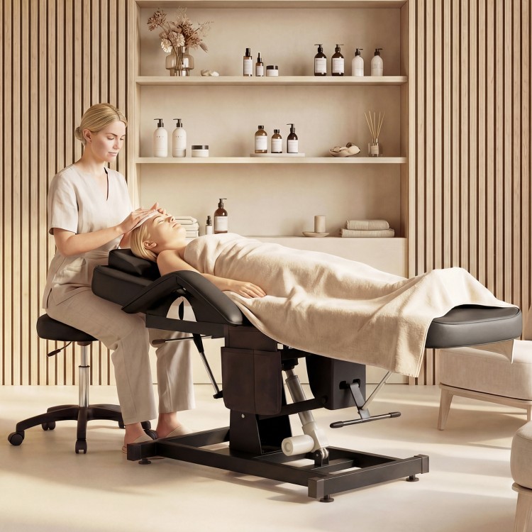 Tattoo chair in black with adjustable backrest and footrest, ideal for esthetician services like facials and nail art.