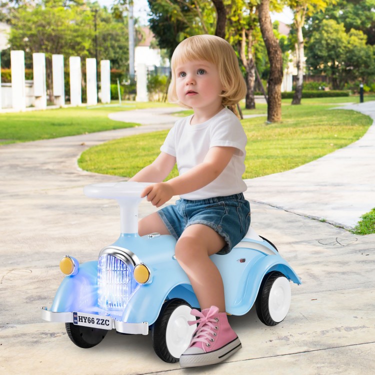 Toddler riding toy car in blue with LED headlights, easy steering wheel, and under-seat storage for outdoor fun.