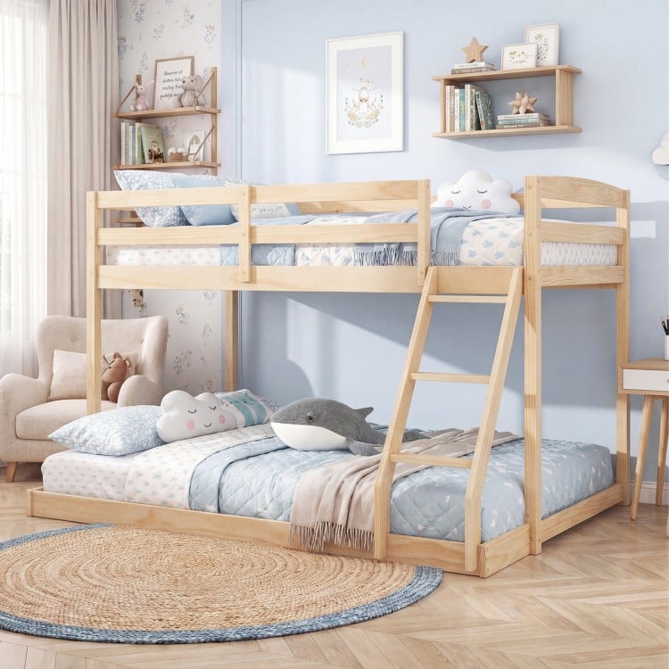 Twin over full low floor bunk bed frame in natural pine wood, featuring guardrails and integrated ladder for kids'.