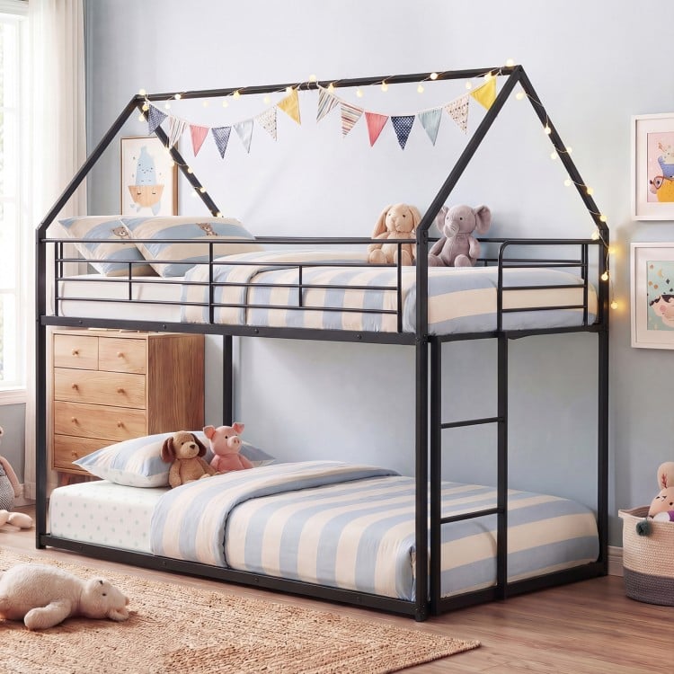 Twin over twin metal bunk bed with roof design in black, showcasing plush bedding and stuffed animals for a cozy kids'.